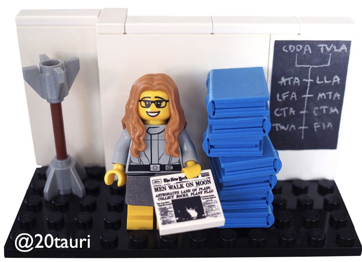 A LEGO minifig version of Margaret Hamilton, lead of the Apollo mission NASA software team, holding a newspaper that says 'Men walk on the moon', standing next to a stack of computer code printouts